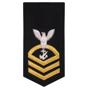 Navy E7 Female Rating Badge: NC Counselor, seaworthy gold on blue