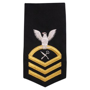 Navy E7 Female Rating Badge: RS Retail Services Specialist, seaworthy gold on blue