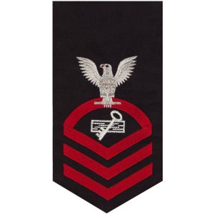 Navy E7 Male Rating Badge: Disbursing Clerk, seaworthy red on blue