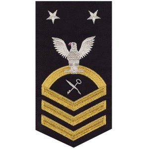 Navy E9 Male Rating Badge: Retail Services Specialist, seaworthy gold on blue